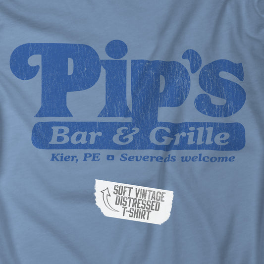 Closeup of a steel blue colored soft Bella+Canvas shirtsleeve t-shirt with the Pips Bar and Grill logo from the TV show Severance in a vintage distressed ink-stamped worn-in style.
