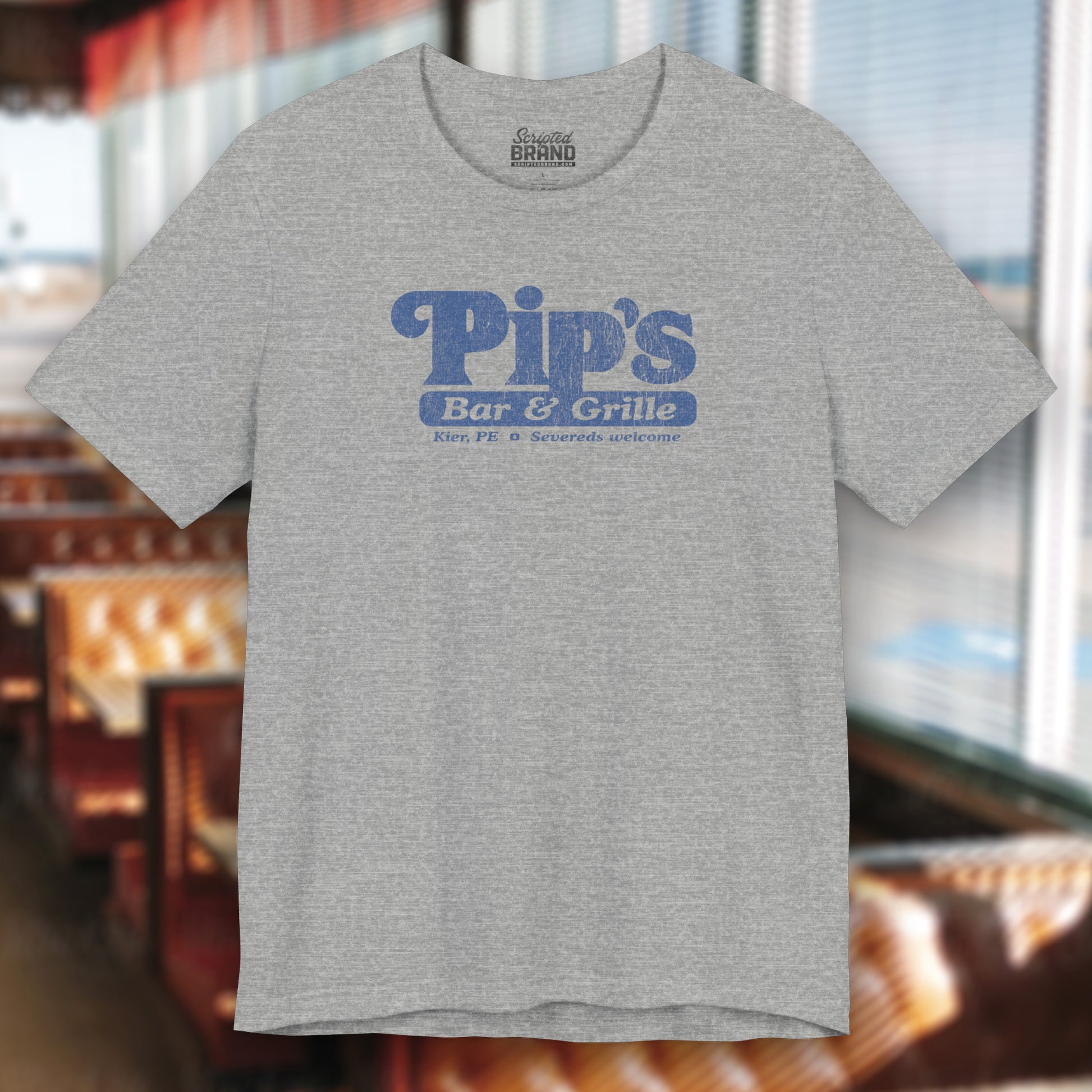 Athletic Heather Gray colored soft Bella+Canvas shirtsleeve t-shirt with the Pips Bar and Grill logo from the TV show Severance in a vintage distressed ink-stamped worn-in style.