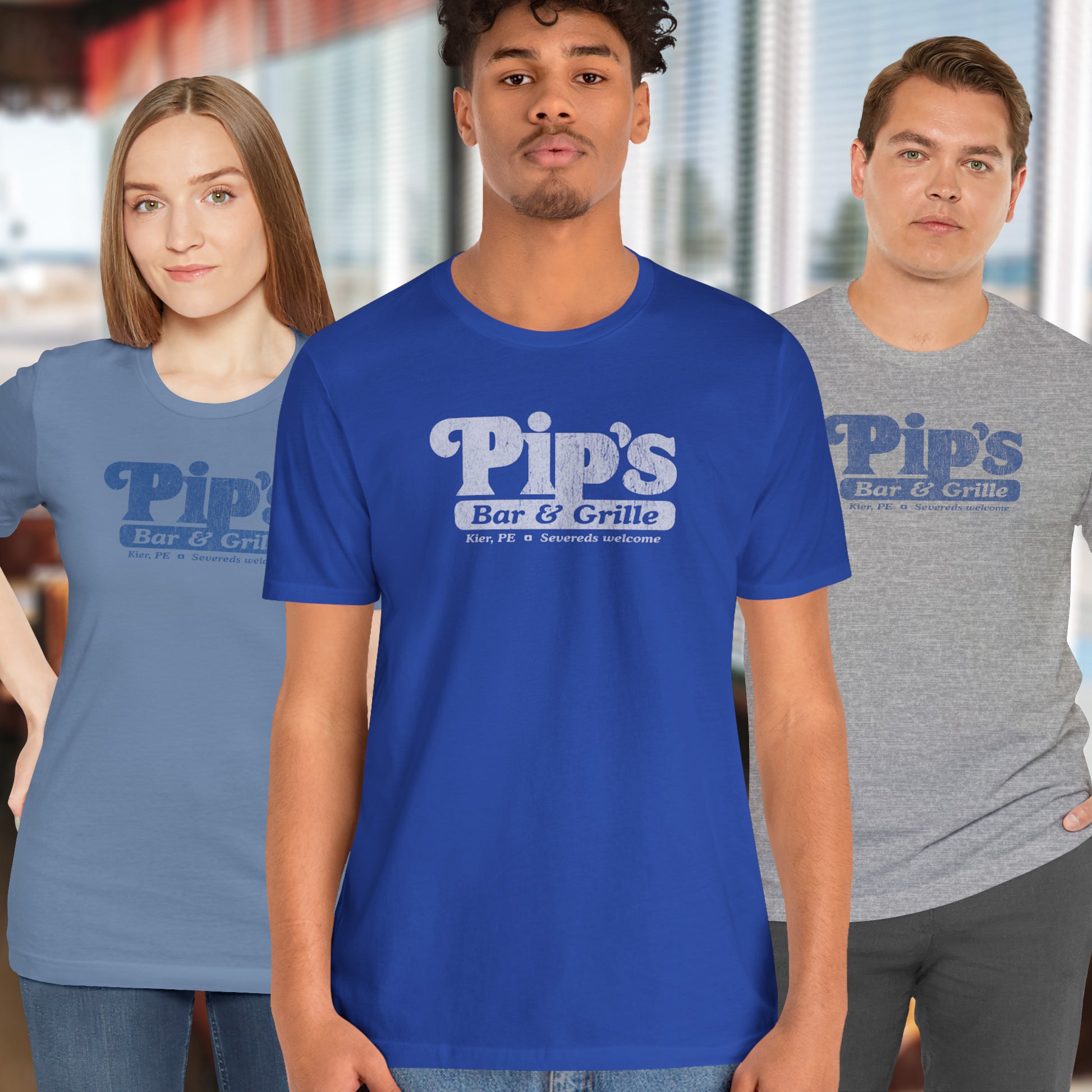 3 models wearing soft Bella+Canvas shirtsleeve t-shirts with the Pips Bar and Grill logo from the TV show Severance in a vintage distressed ink-stamped worn-in style.