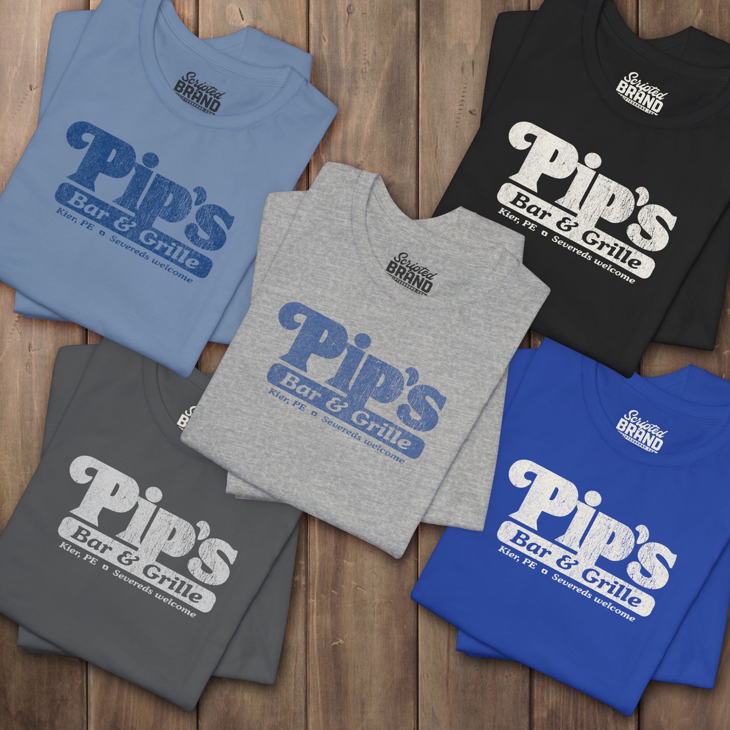 Five folded Bella+Canvas t-shirts with the Pips Bar and Grill logo from the TV show Severance in a vintage distressed style.