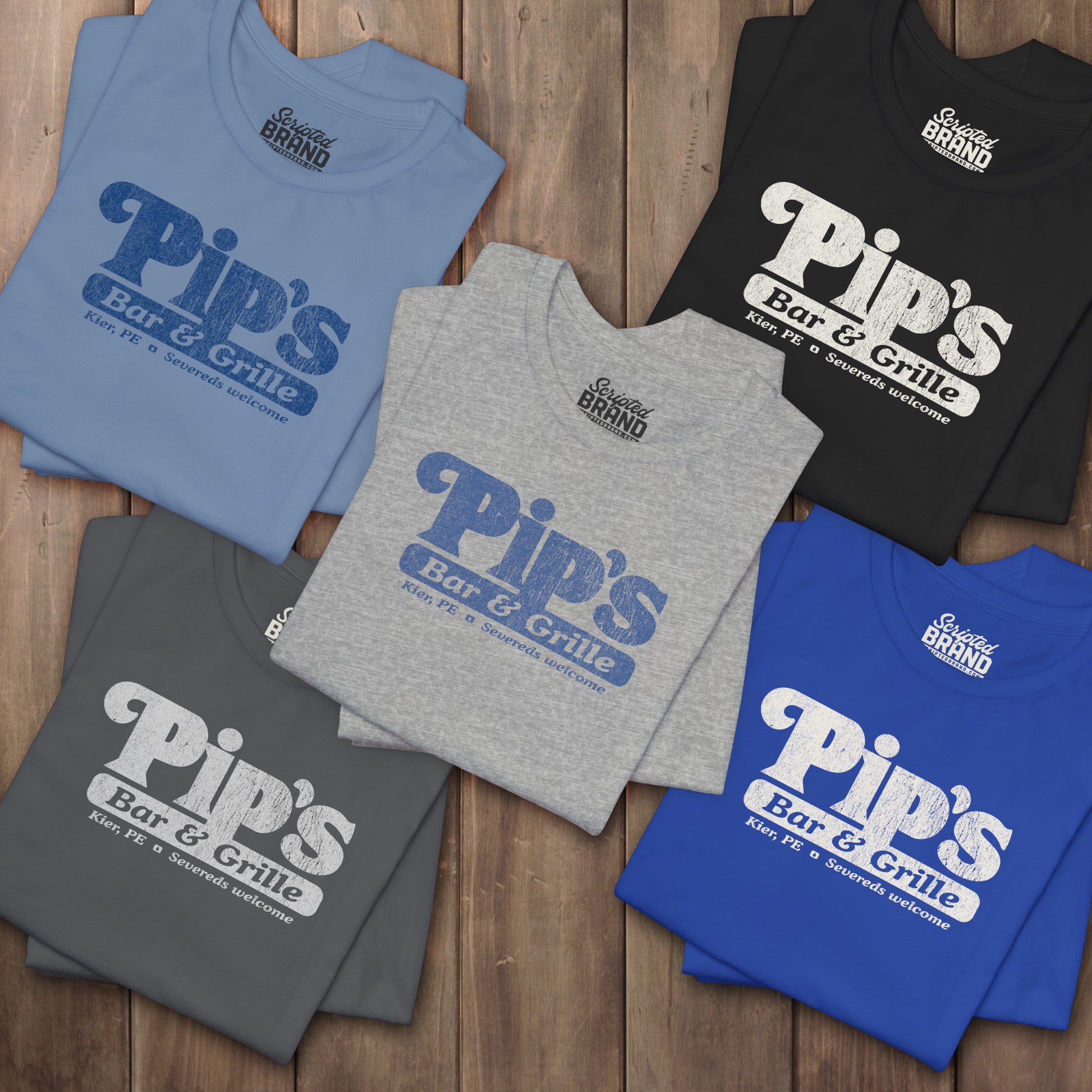 Five folded Bella+Canvas t-shirts with the Pips Bar and Grill logo from the TV show Severance in a vintage distressed style.