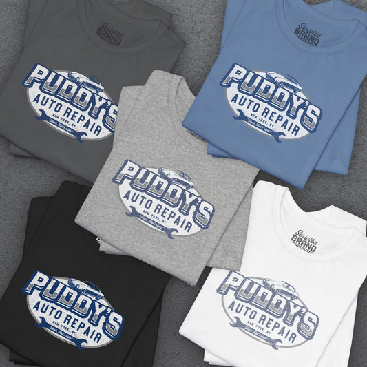 Group of 5 Soft short-sleeve t-shirts featuring a Puddy's Auto Repair graphic designed by ScriptedBrand inspired by the TV show Seinfeld in a vintage distressed ink-stamped worn-in style.