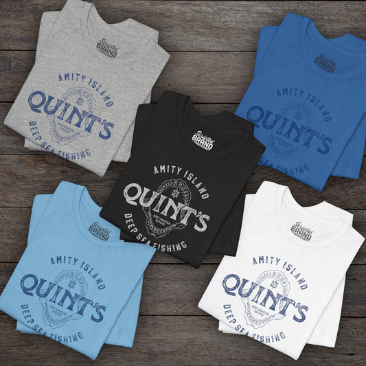 Group of 5 folded soft short-sleeve t-shirts featuring the Quint's Deep Sea Fishing Boat Charters logo graphic inspired by the movie Jaws in a vintage distressed ink-stamped worn-in style.