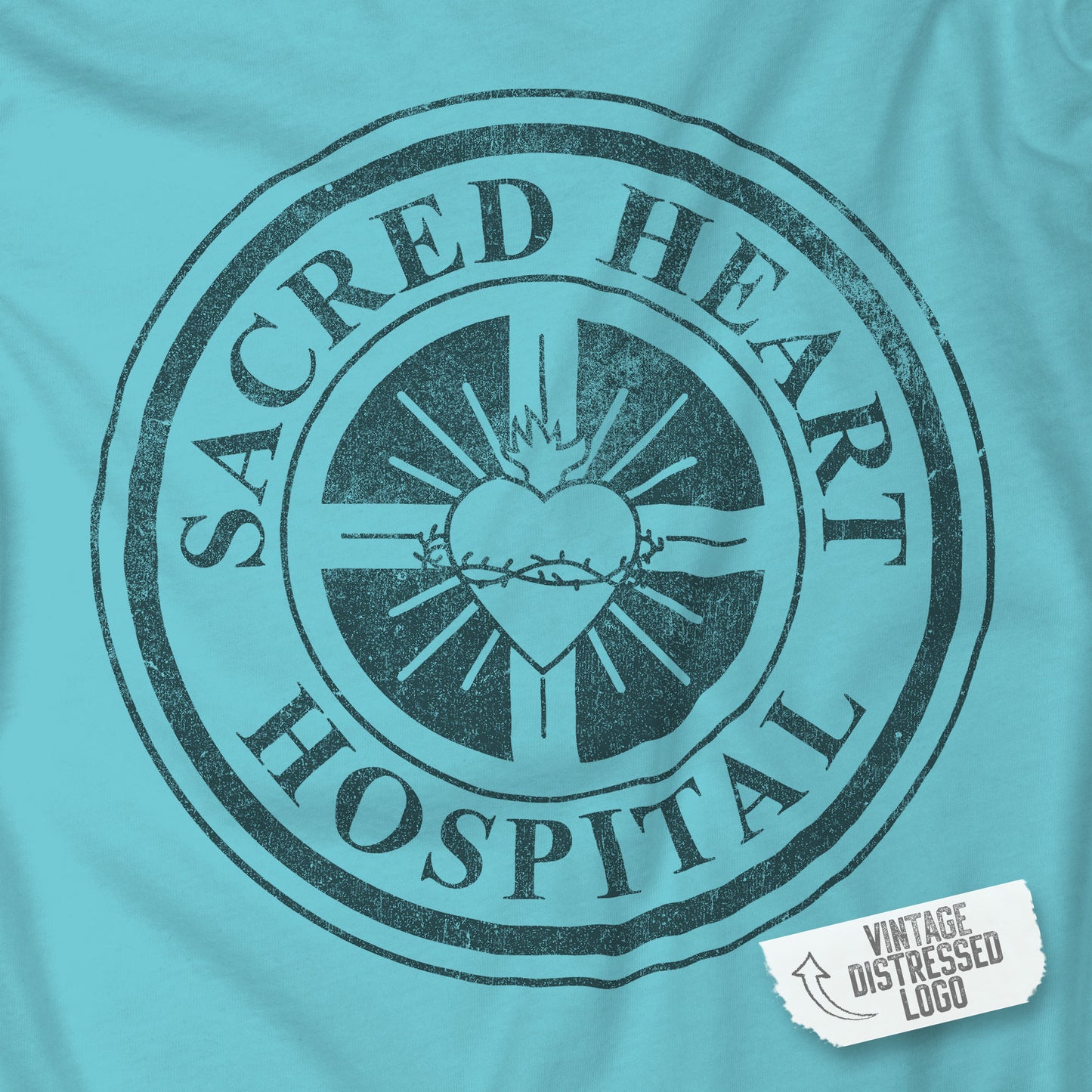 Closeup of turquoise Bella Canvas 3001 tee with vintage distressed Sacred Heart Hospital logo from Scrubs printed on chest.