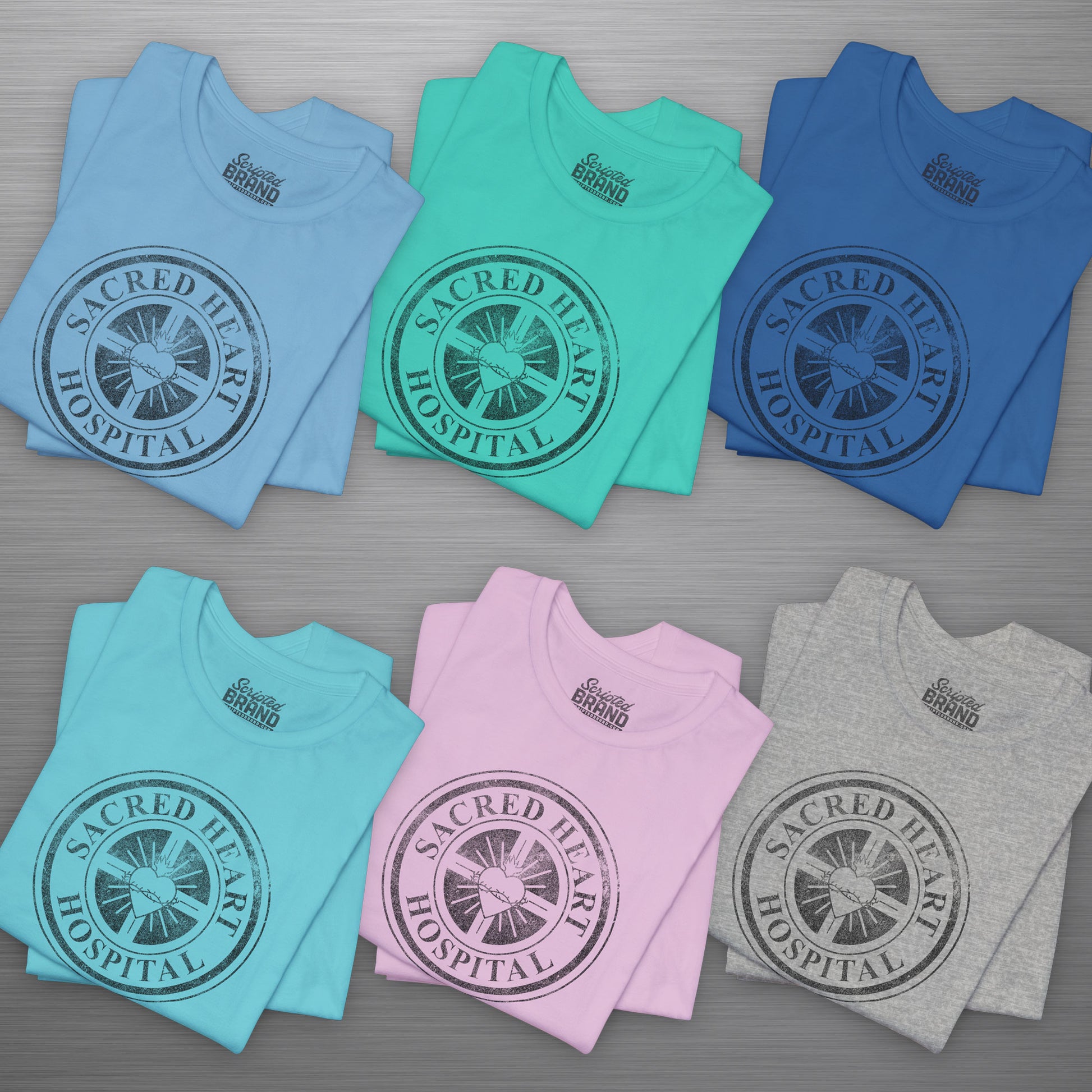 Six folded Bella Canvas 3001 tees with vintage distressed Sacred Heart Hospital logo from Scrubs printed on chest.