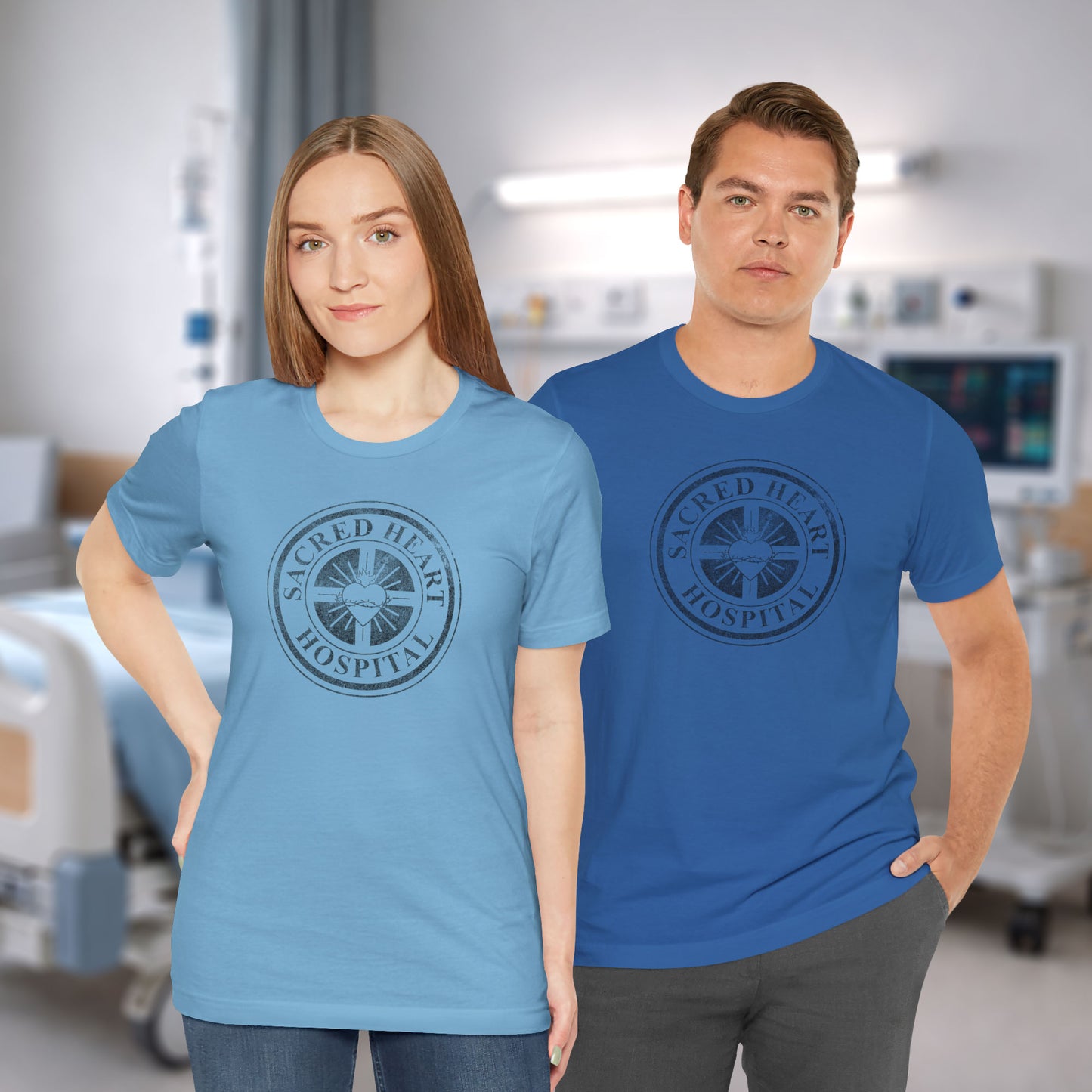 Two people wearing blue Bella Canvas 3001 tees with vintage distressed Sacred Heart Hospital logo from Scrubs printed on chest.