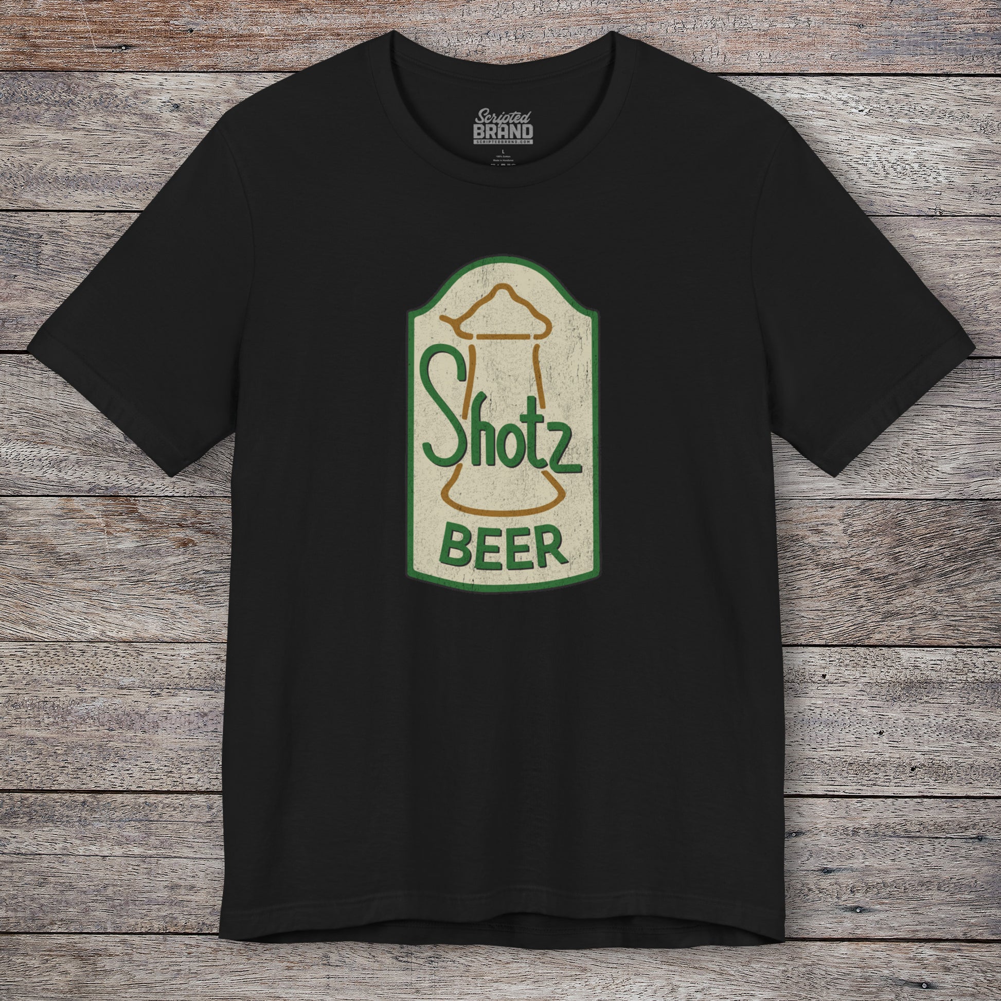 Front view of black t-shirt with vintage Shotz Beer Brewery logo graphic, inspired by TV show Laverne & Shirley.