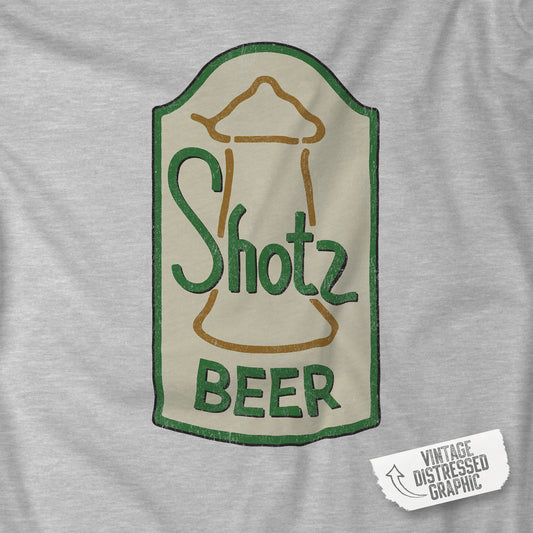 Closeup of Heather grey t-shirt with vintage Shotz Beer Brewery logo graphic, inspired by TV show Laverne & Shirley.