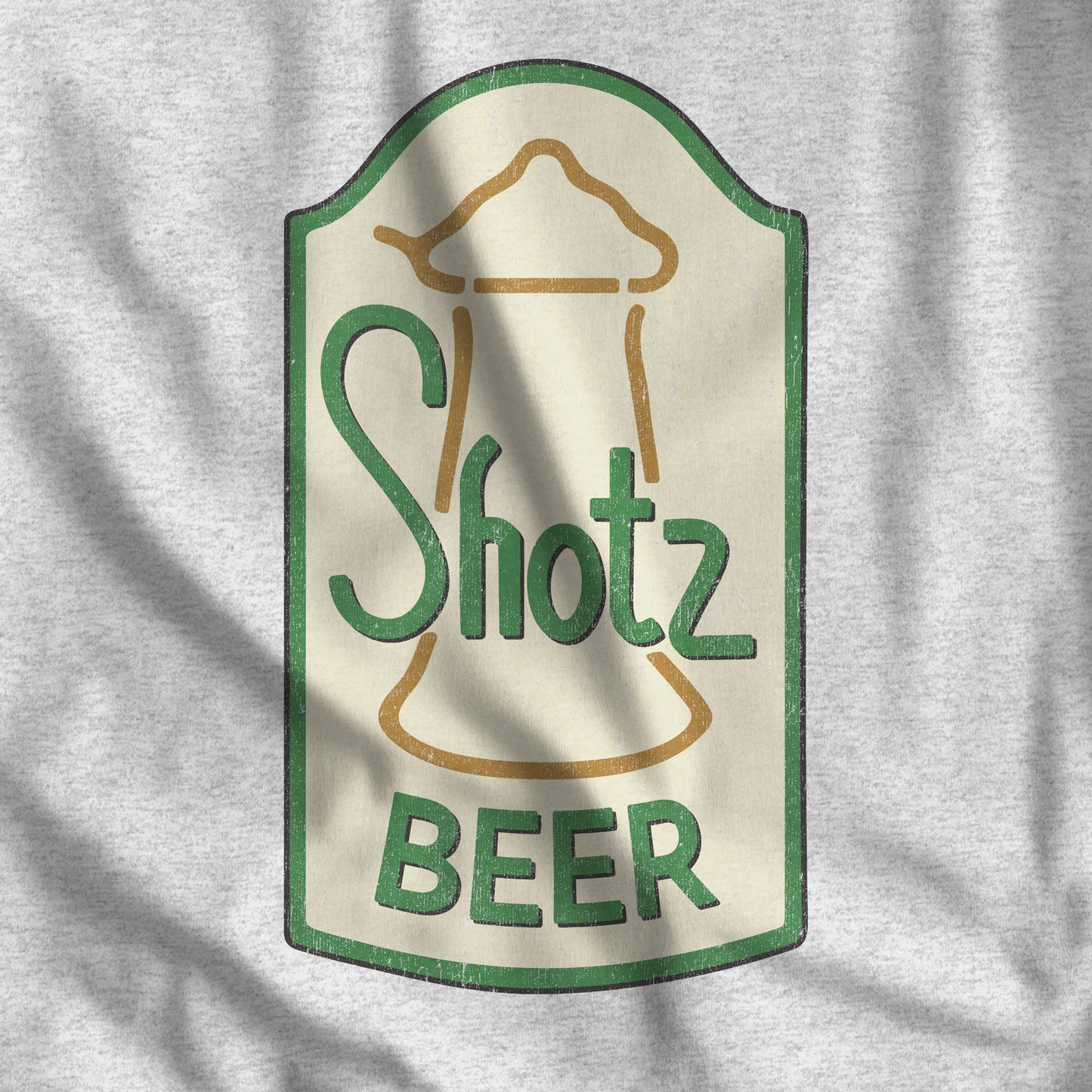 Closeup of Heather gray t-shirt with distressed Shotz Beer Brewery logo graphic, inspired by TV show Laverne & Shirley.