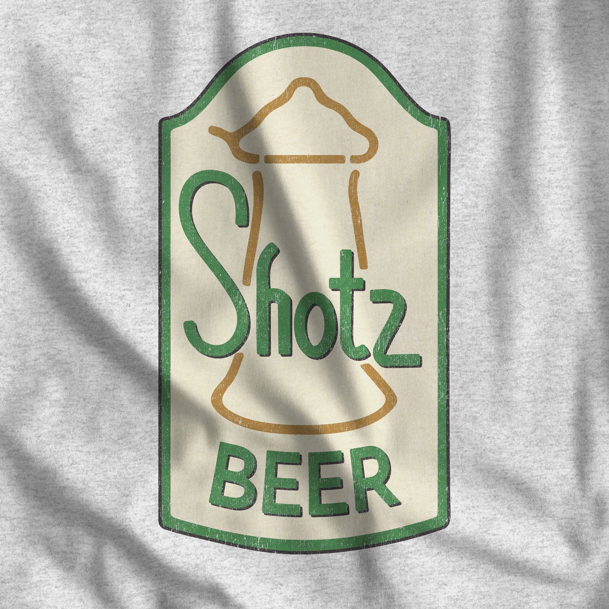 Closeup of Heather gray t-shirt with distressed Shotz Beer Brewery logo graphic, inspired by TV show Laverne & Shirley.