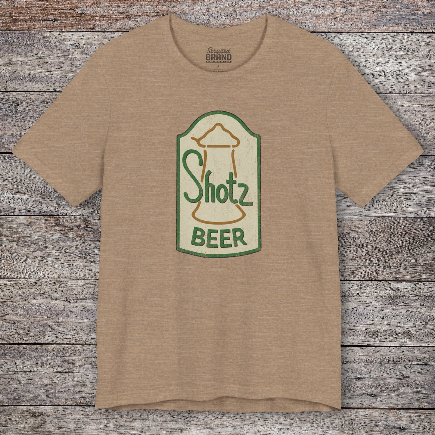Front view of heather tan t-shirt with vintage Shotz Beer Brewery logo graphic, inspired by TV show Laverne & Shirley.