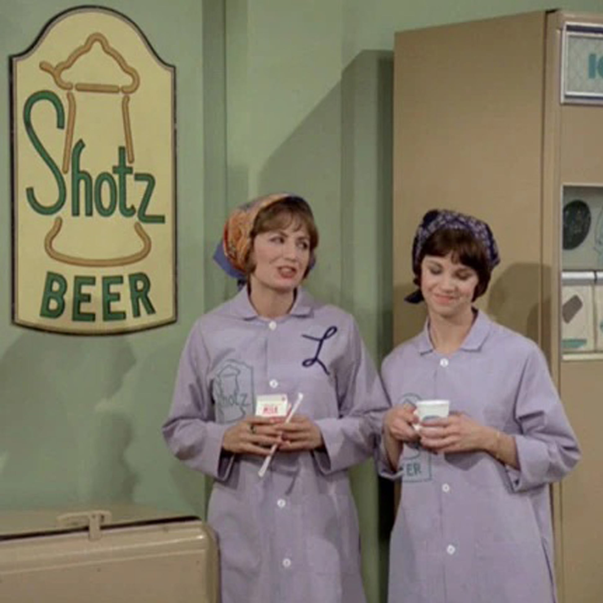 Scene from TV show Laverne & Shirley, with Shotz Beer Brewery logo graphic on wall in background.