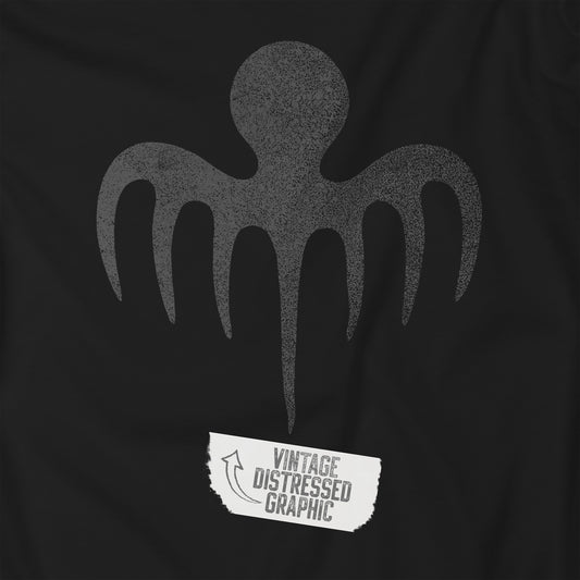 Closeup view of a black t-shirt with a vintage distressed logo of the fictional James Bond criminal organization SPECTRE.