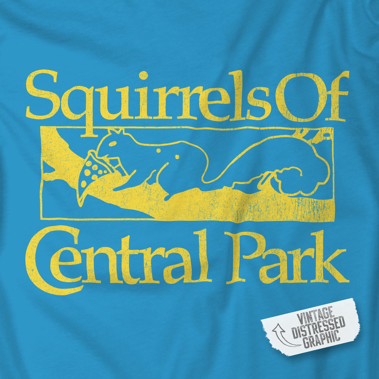 Closeup of Aqua blue unisex t-shirt with distressed yellow “Squirrels of Central Park” graphic, worn by Eva Garvey in the show Bad Sisters.