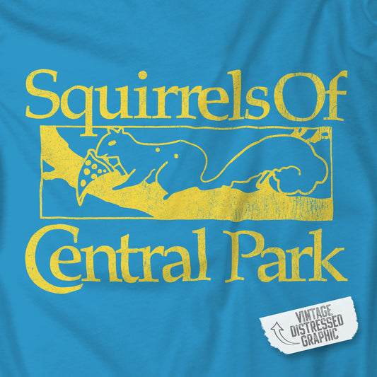 Closeup of Aqua blue unisex t-shirt with distressed yellow “Squirrels of Central Park” graphic, worn by Eva Garvey in the show Bad Sisters.
