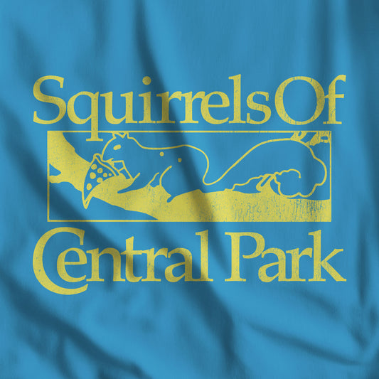 Closeup of Aqua blue Bella+Canvas t-shirt with distressed yellow “Squirrels of Central Park” graphic, worn by Eva Garvey in the TV show Bad Sisters