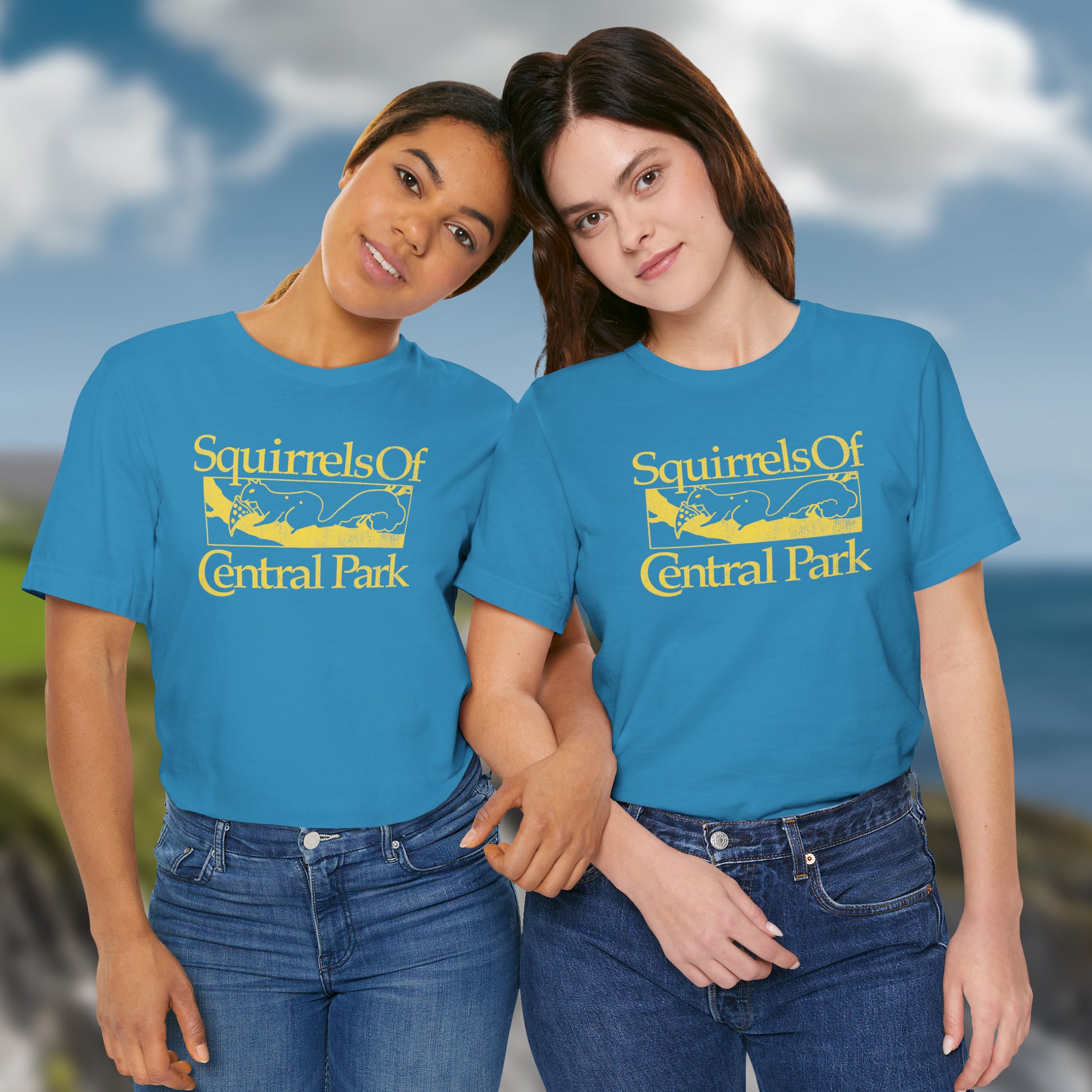 2 women wearing aqua blue unisex t-shirt with distressed “Squirrels of Central Park” graphic, worn by Eva Garvey in the show Bad Sisters.