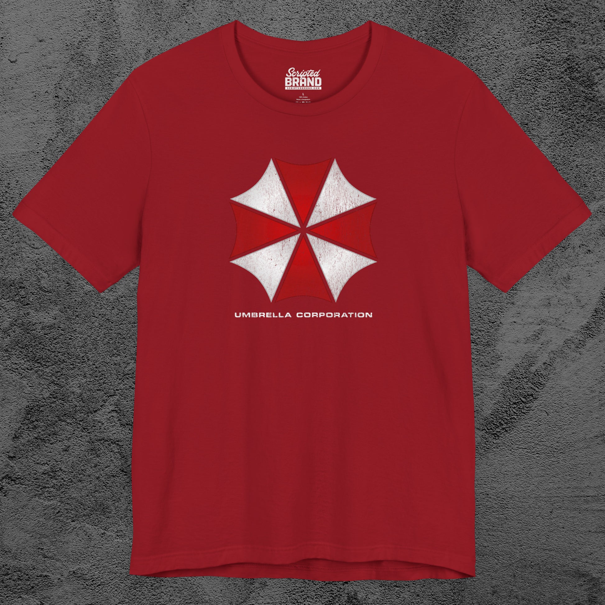 Red t-shirt featuring the Umbrella Corp logo from the video game and movie franchise Resident Evil in a vintage distressed style.