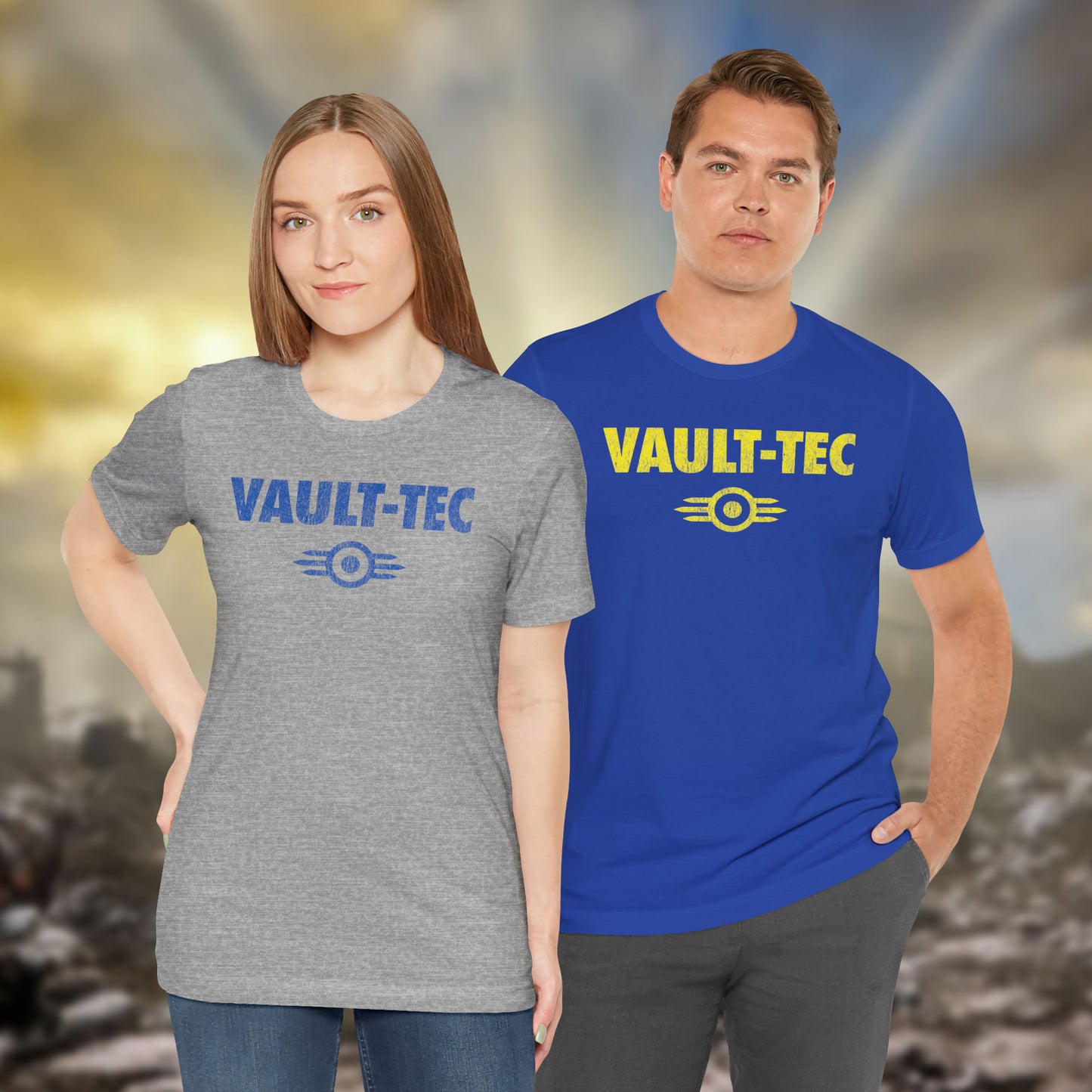 Two people wearing t-shirts featuring the Vault-Tec logo graphic from the video game Fallout in a vintage distressed style. 