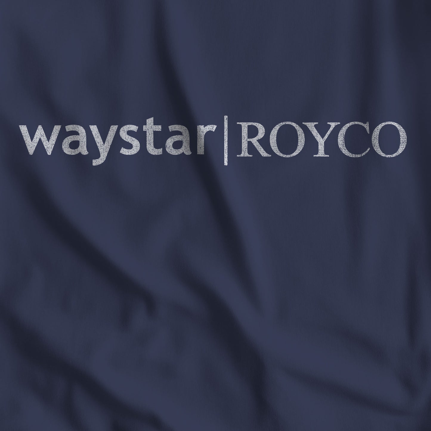 Closeup of Navy Blue t-shirt with the Waystar Royco logo from the show Succession in a vintage distressed style.