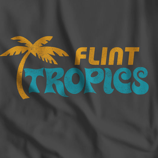 Closeup of Black Bella+Canvas t-shirt with the Flint Tropics logo from the movie Semi-Pro in a vintage distressed style.