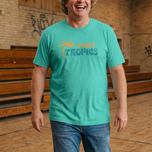 Man wearing teal Bella+Canvas t-shirt with the Flint Tropics logo from the movie Semi-Pro in a vintage distressed style.