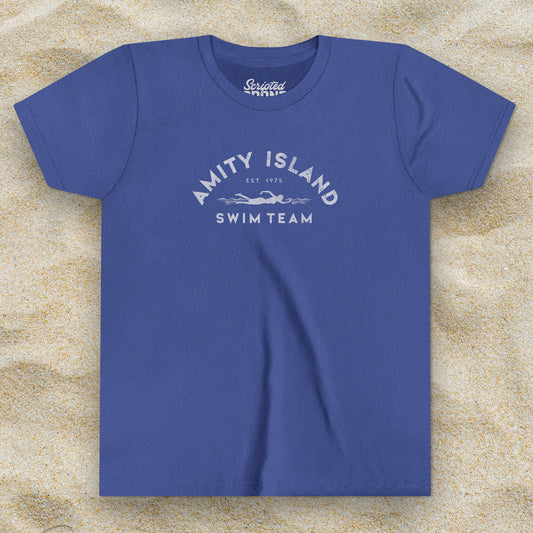 Front view of a Heather royal blue colored Soft unisex Youth Sizes Bella+Canvas 3001Y short-sleeve t-shirt featuring an Amity Island Swim Team logo graphic, designed by ScriptedBrand, and  inspired by the movie Jaws in a vintage distressed style.
