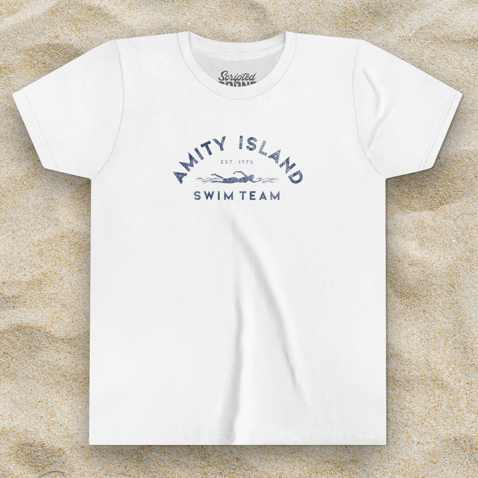Front view of a white colored Soft unisex Youth Sizes Bella+Canvas 3001Y short-sleeve t-shirt featuring an Amity Island Swim Team logo graphic, designed by ScriptedBrand, and  inspired by the movie Jaws in a vintage distressed style.
