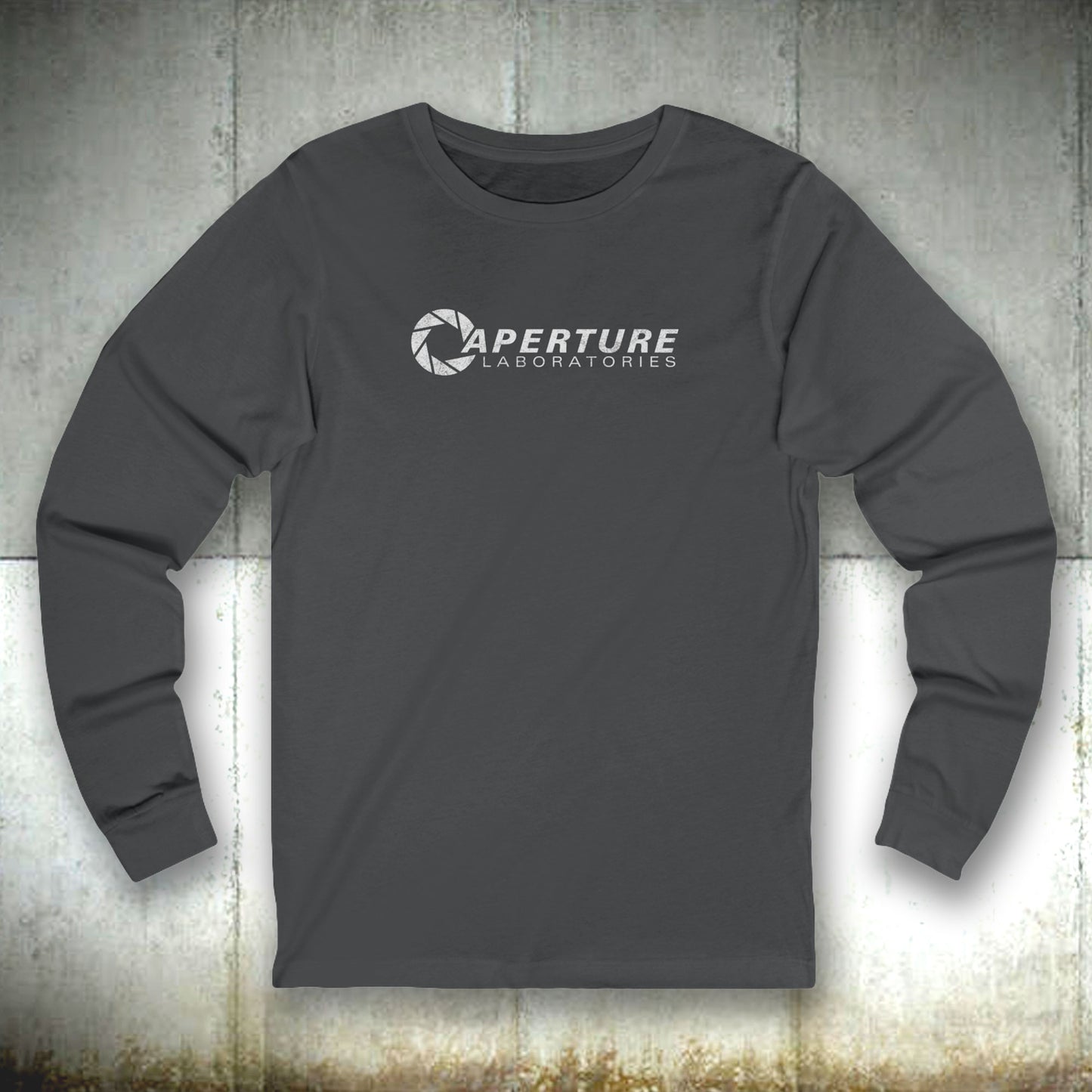 Front view of a asphalt gray colored soft long-sleeve t-shirt featuring the Aperture Laboratories logo from the video game Portal and Portal 2 in a vintage distressed style, sold by ScriptedBrand. 