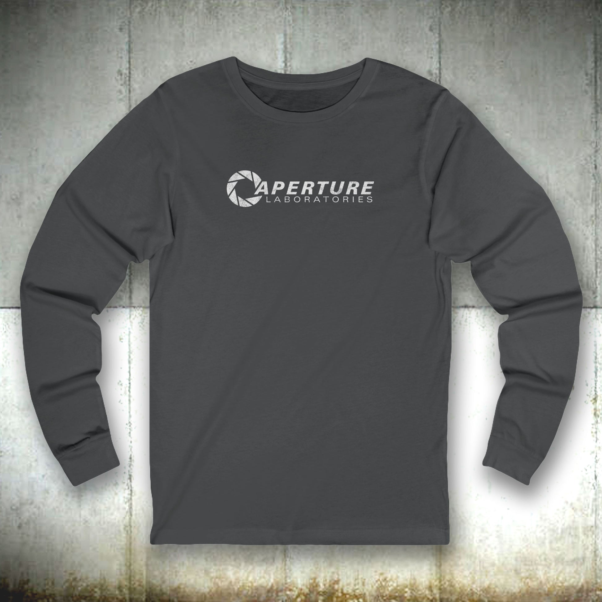 Front view of a asphalt gray colored soft long-sleeve t-shirt featuring the Aperture Laboratories logo from the video game Portal and Portal 2 in a vintage distressed style, sold by ScriptedBrand. 