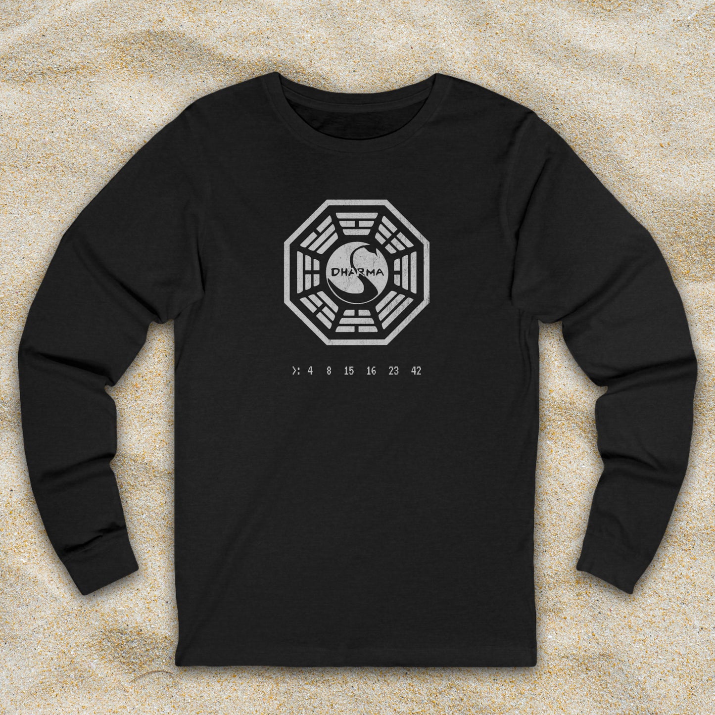 Heather Black long sleeve t-shirt with distressed Dharma Initiative Swan Station logo and hatch numbers from LOST, shown on beach sand