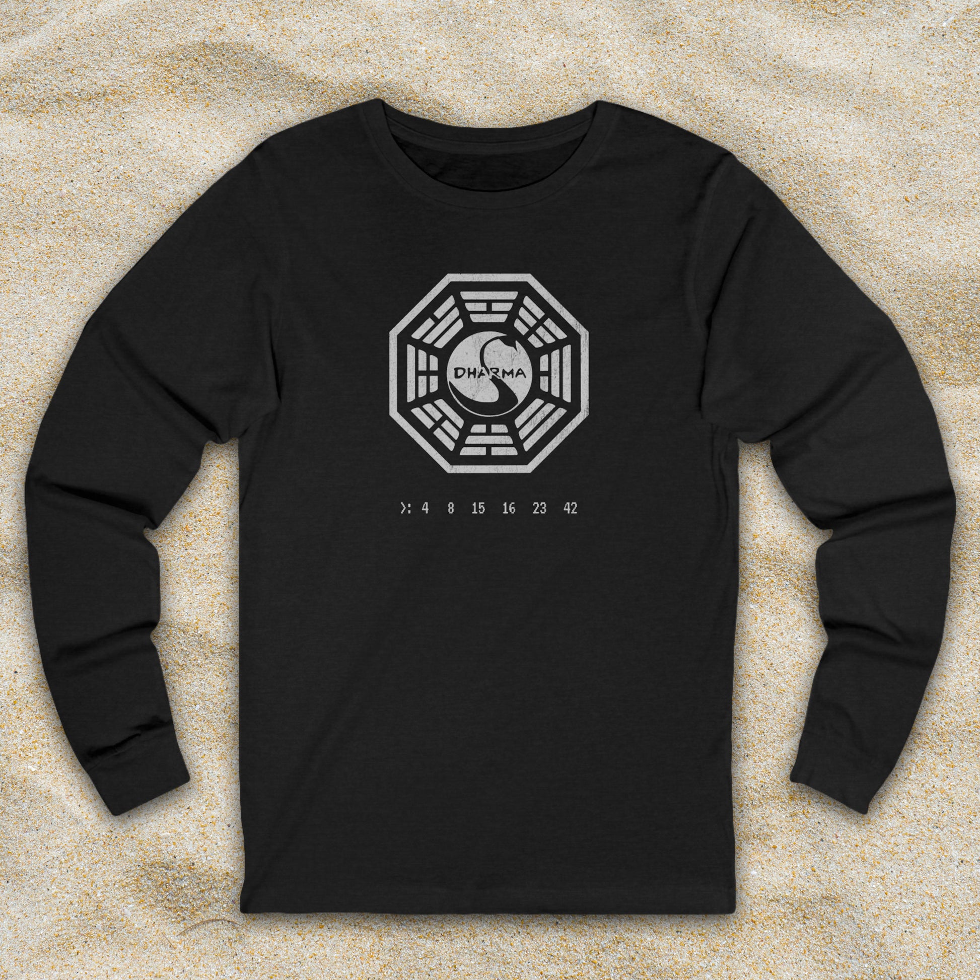 Heather Black long sleeve t-shirt with distressed Dharma Initiative Swan Station logo and hatch numbers from LOST, shown on beach sand