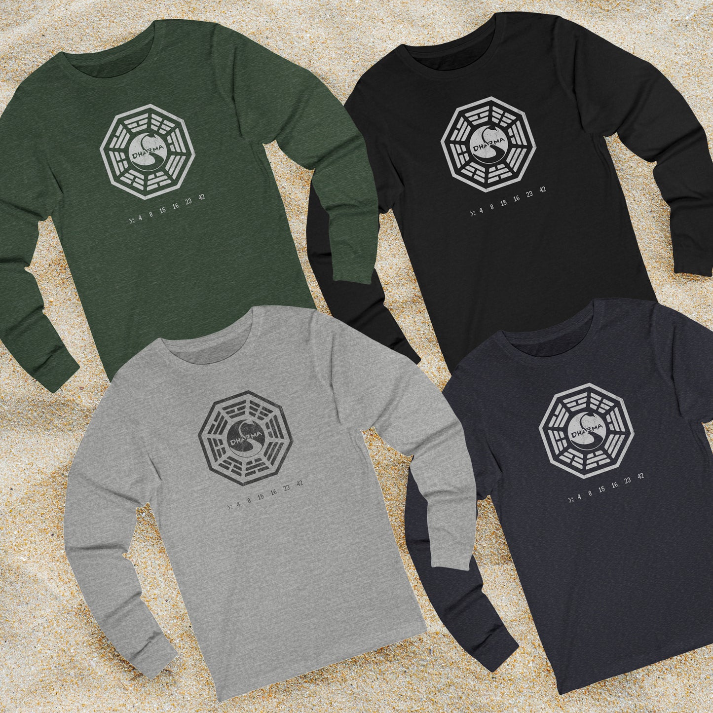 Four long sleeve t-shirts with distressed Dharma Initiative Swan Station logo and hatch numbers from LOST, shown on beach sand