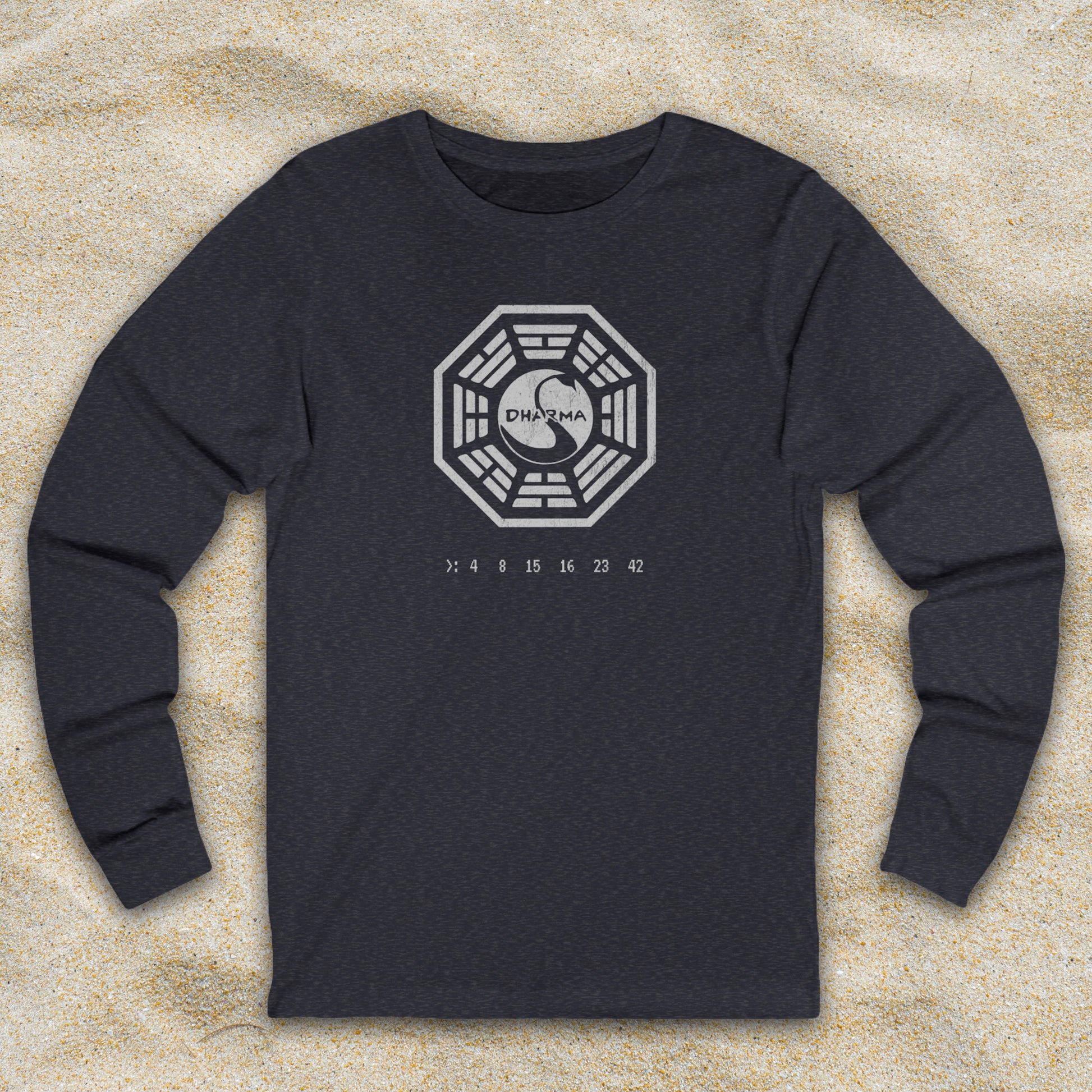 Heather Navy blue long sleeve t-shirt with distressed Dharma Initiative Swan Station logo and hatch numbers from LOST, shown on beach sand