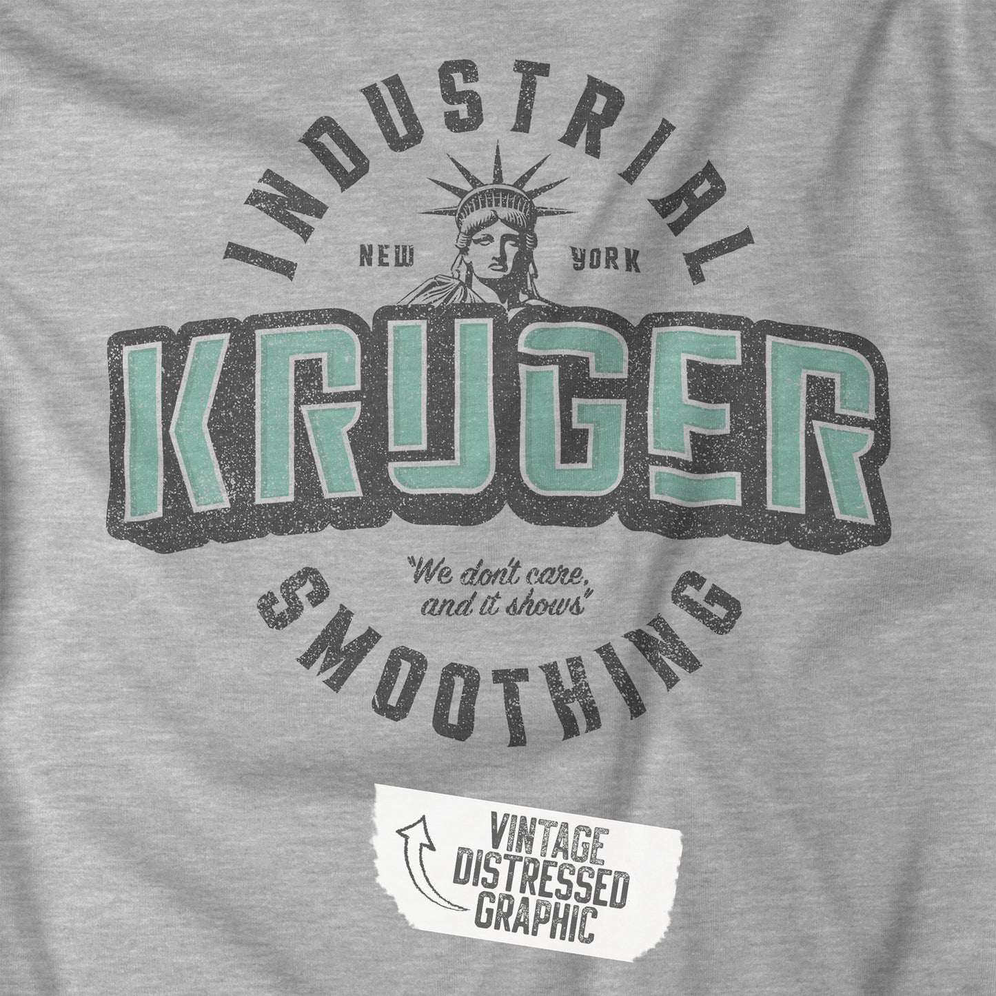 Closeup view of a grey athletic heather colored soft unisex Bella+Canvas 3501 long-sleeve t-shirt featuring a Kruger Industrial Smoothing logo graphic, designed by ScriptedBrand in a vintage distressed style, and  inspired by the TV show Seinfeld. Includes the Statue of Liberty and the the slogan "We don't care and it shows".