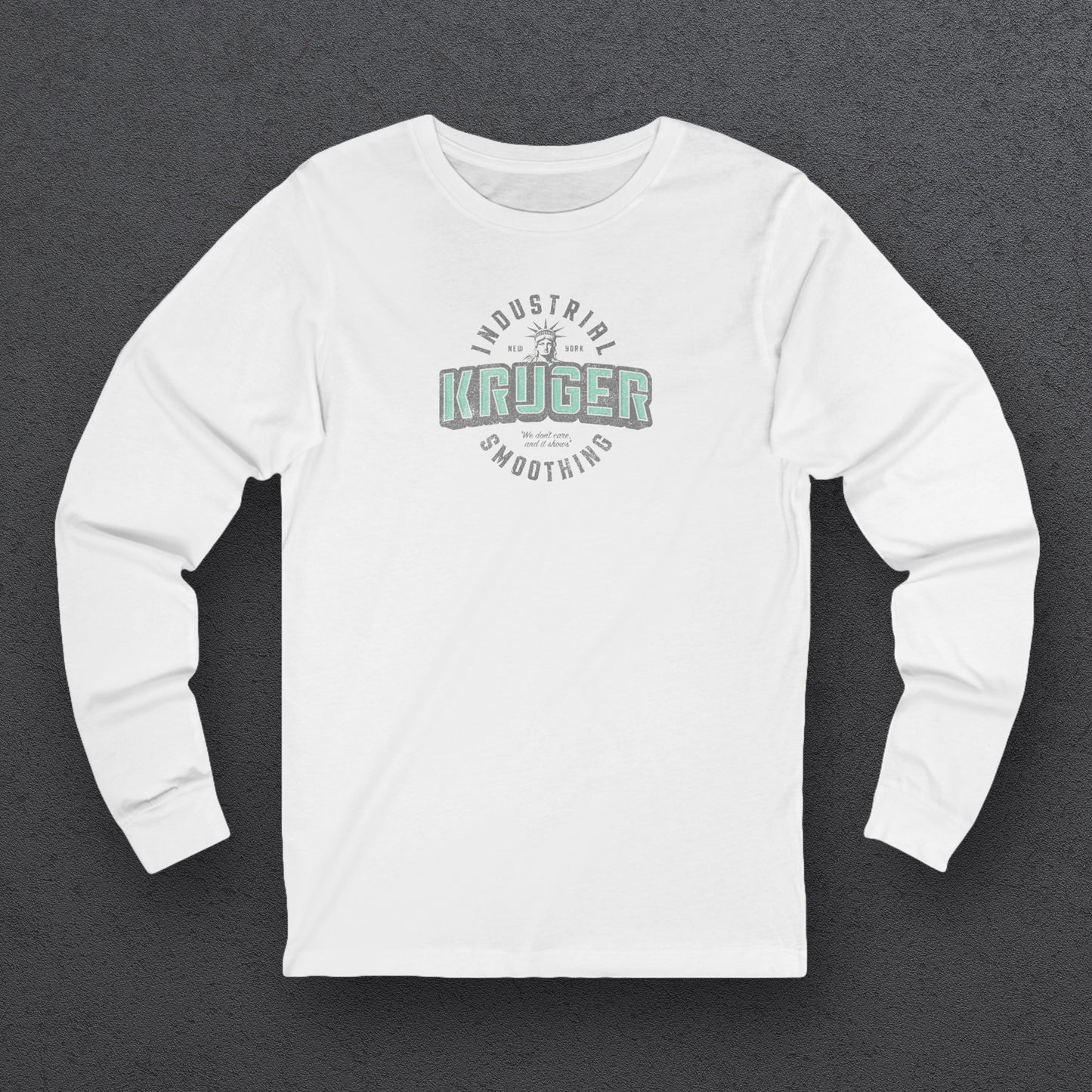 Front view of a white colored soft unisex Bella+Canvas 3501 long-sleeve t-shirt featuring a Kruger Industrial Smoothing logo graphic, designed by ScriptedBrand in a vintage distressed style, and  inspired by the TV show Seinfeld. Includes the Statue of Liberty and the the slogan "We don't care and it shows".