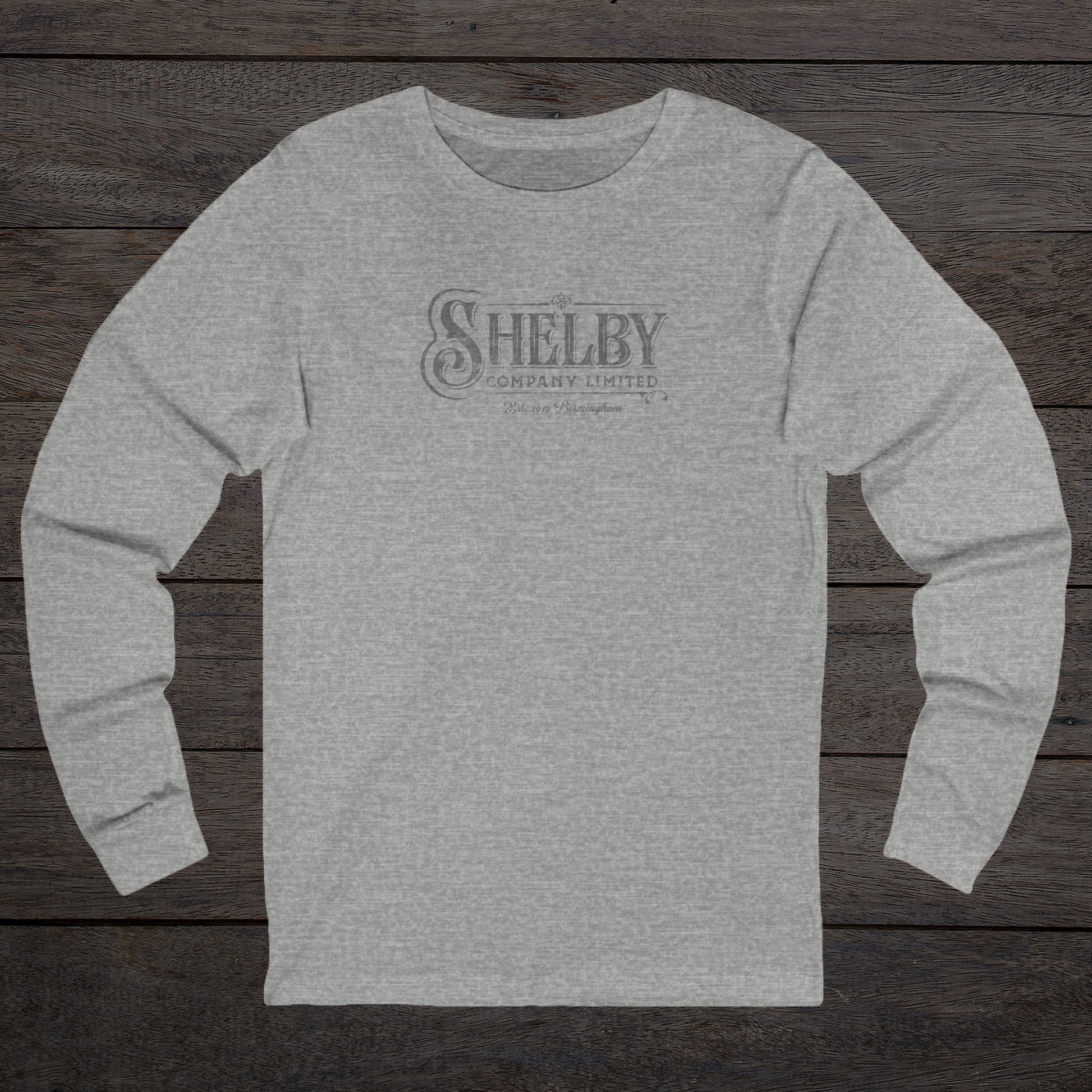 Front view of an athletic heather gray soft unisex Bella-Canvas 3501 long-sleeve t-shirt featuring the Shelby Company Limited logo from the show Peaky Blinders in a vintage distressed style, sold by ScriptedBrand.