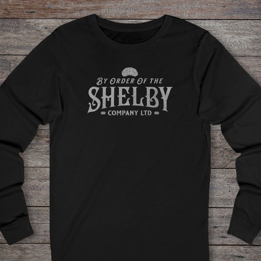 Front view of a black Shelby Company Ltd long-sleeve tee with vintage logo from Peaky Blinders, featuring flat cap and razor blades.