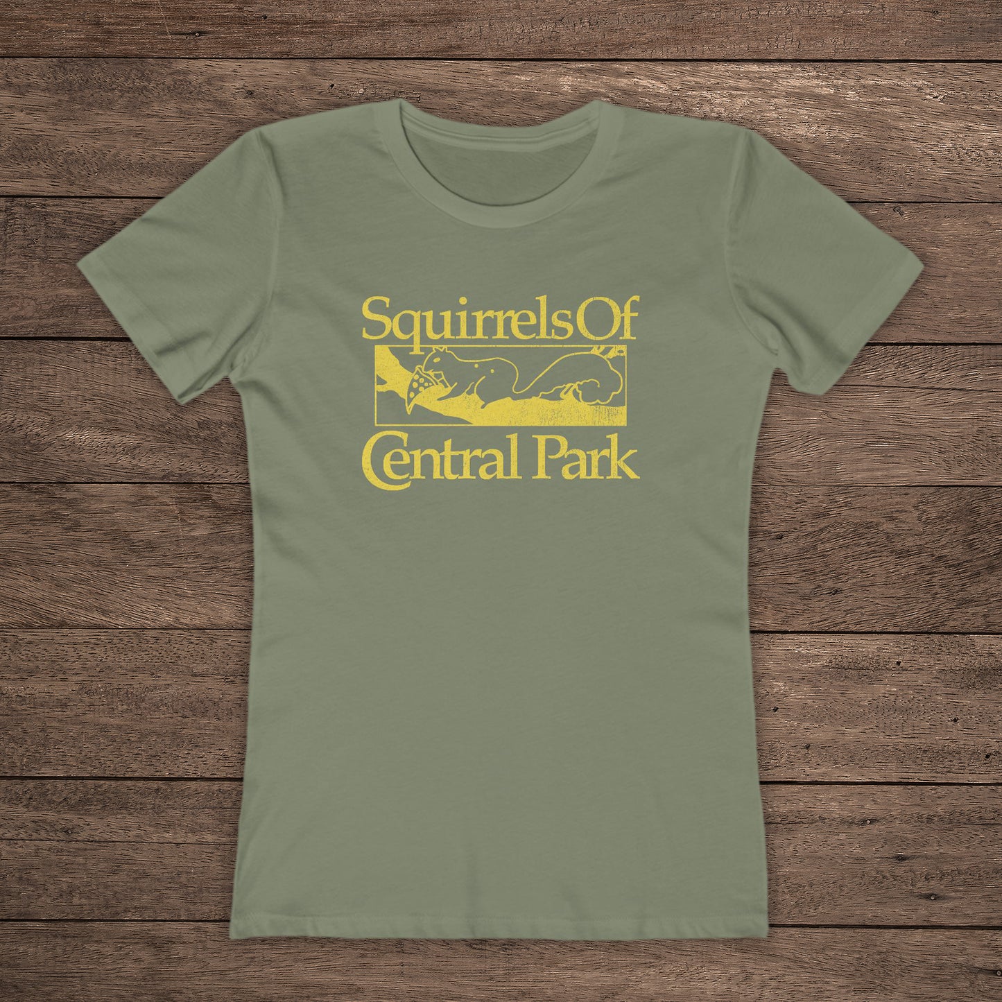 Front view of olive green women’s t-shirt with distressed yellow “Squirrels of Central Park” logo inspired by Bad Sisters.
