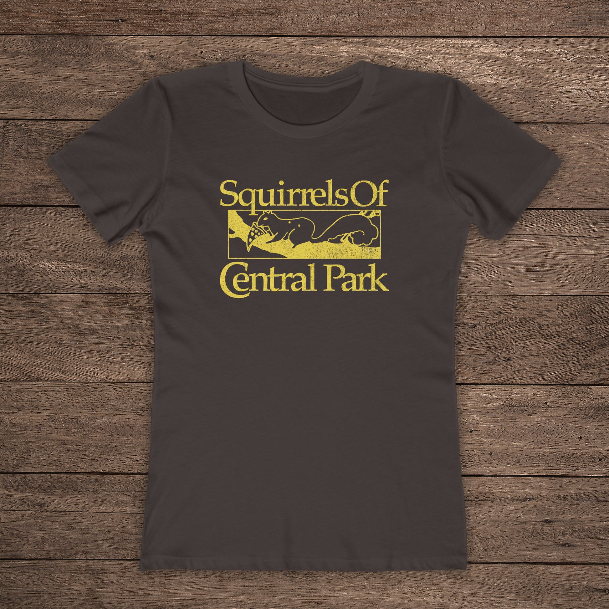 Front view of Chocolate brown women’s t-shirt with distressed yellow “Squirrels of Central Park” logo inspired by Bad Sisters.