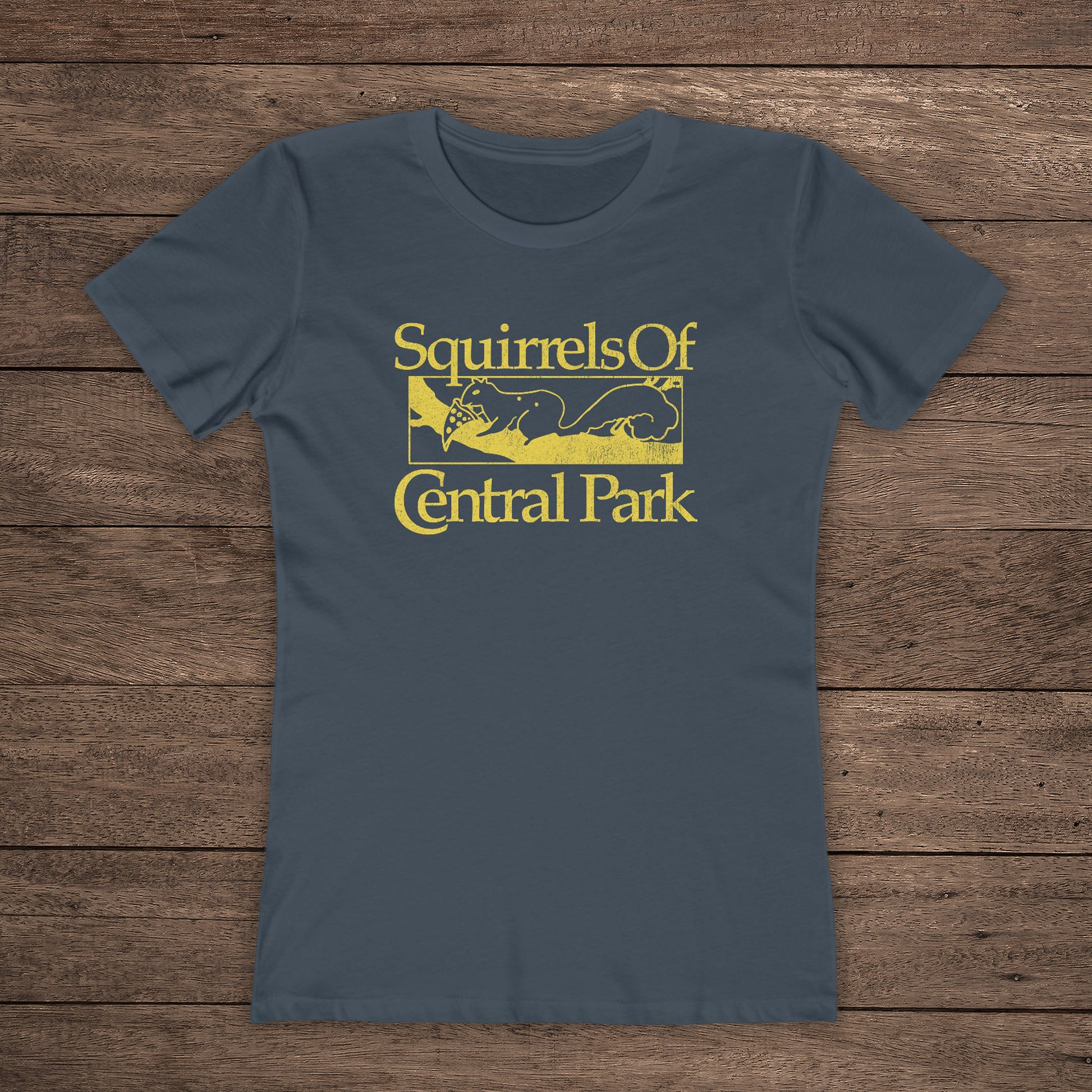 Front view of indigo blue women’s t-shirt with distressed yellow “Squirrels of Central Park” logo inspired by Bad Sisters.
