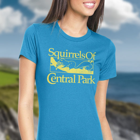 Woman wearing a Turquoise women’s t-shirt with distressed yellow “Squirrels of Central Park” logo inspired by Bad Sisters.