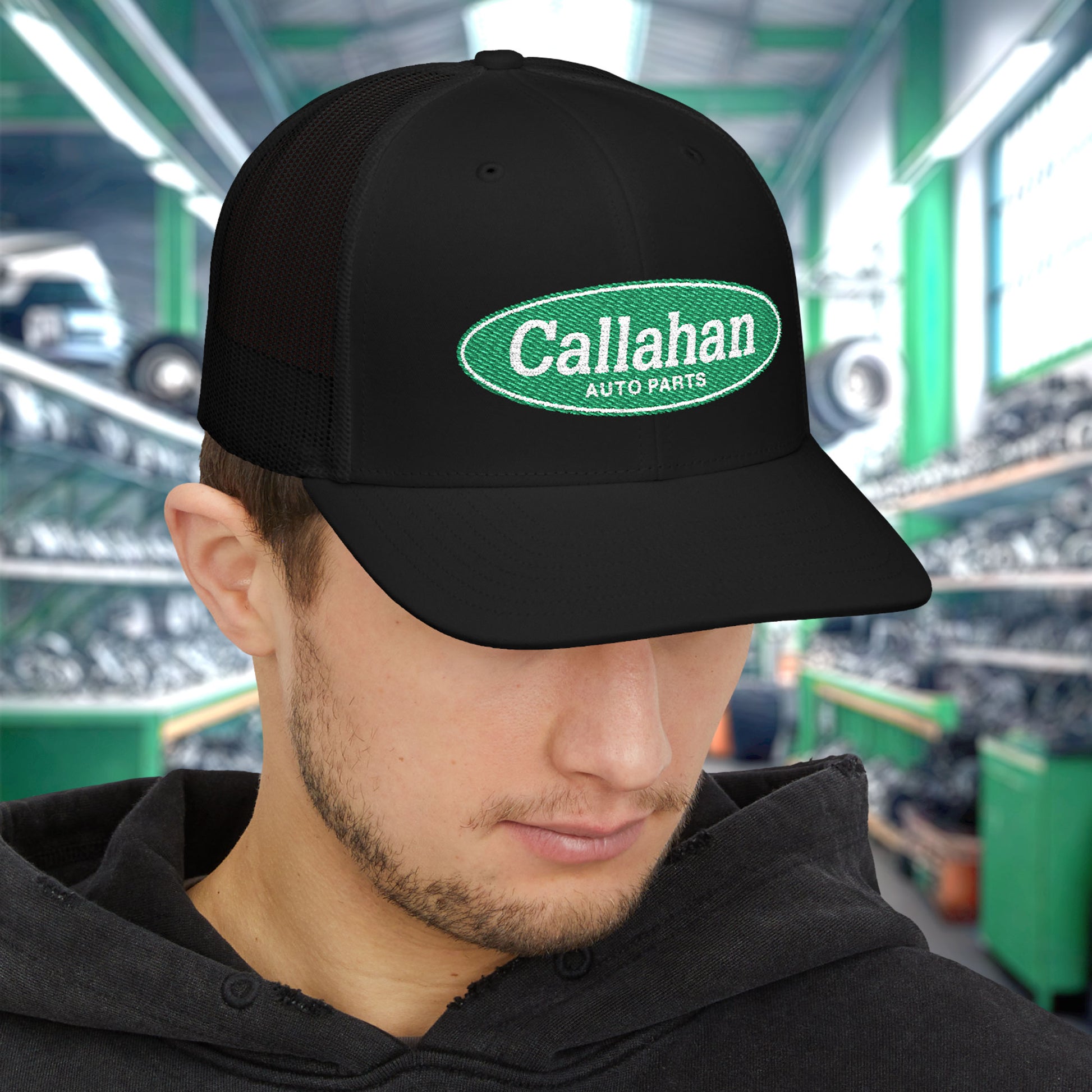 Man wearing Black Richardson 112 trucker cap with embroidered green Callahan Auto Parts logo inspired by Tommy Boy.