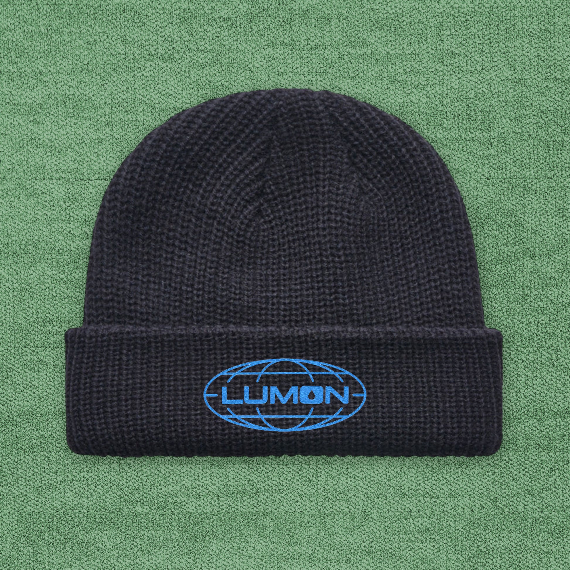Fisherman-style AS Colour cuff beanie with embroidered blue Lumon Industries logo from Severance, ribbed knit hat.
