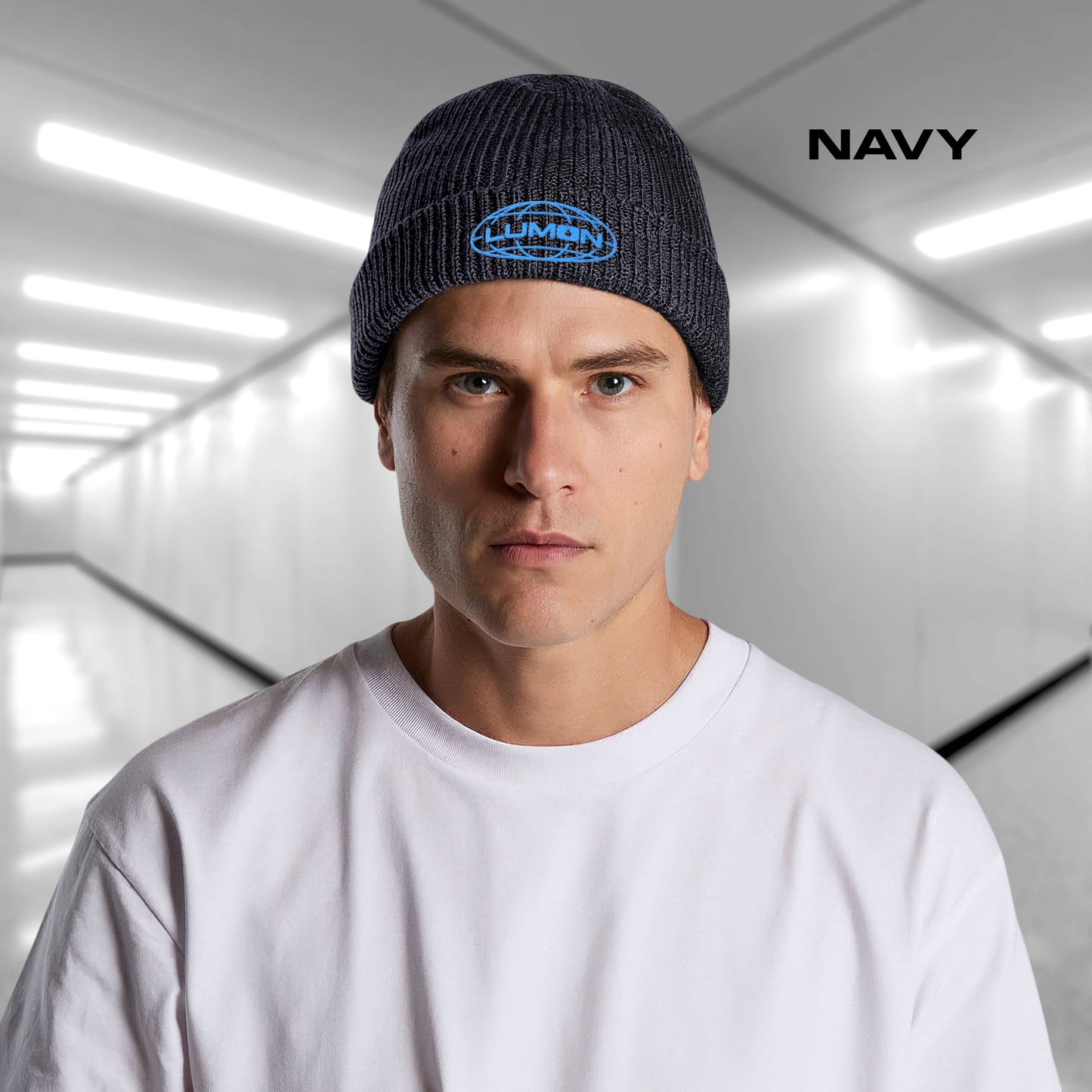 Man wearing a Navy blue AS Colour cuff beanie with embroidered blue Lumon Industries logo from Severance, fisherman-style ribbed knit hat.