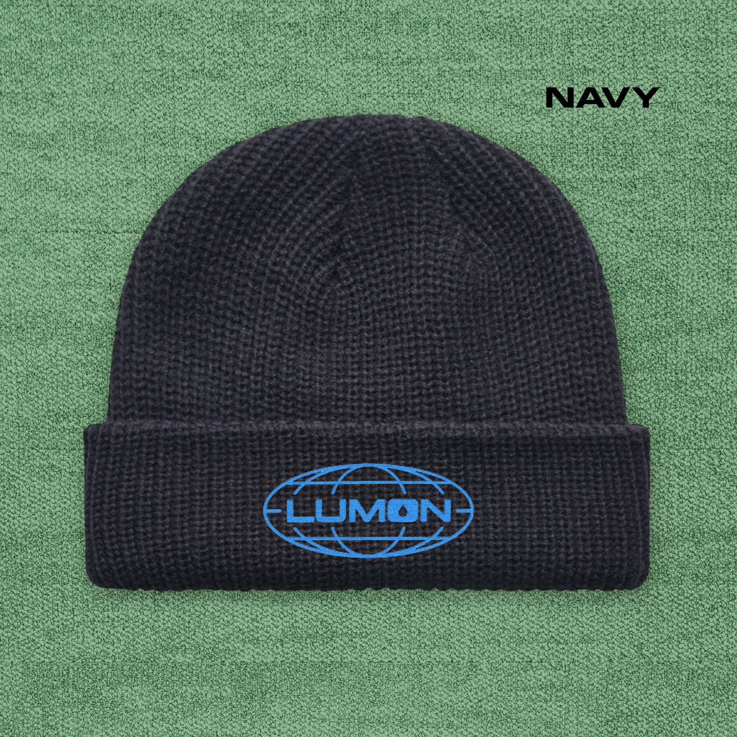 Navy AS Colour cuff beanie with embroidered blue Lumon Industries logo from Severance, fisherman-style ribbed knit hat.