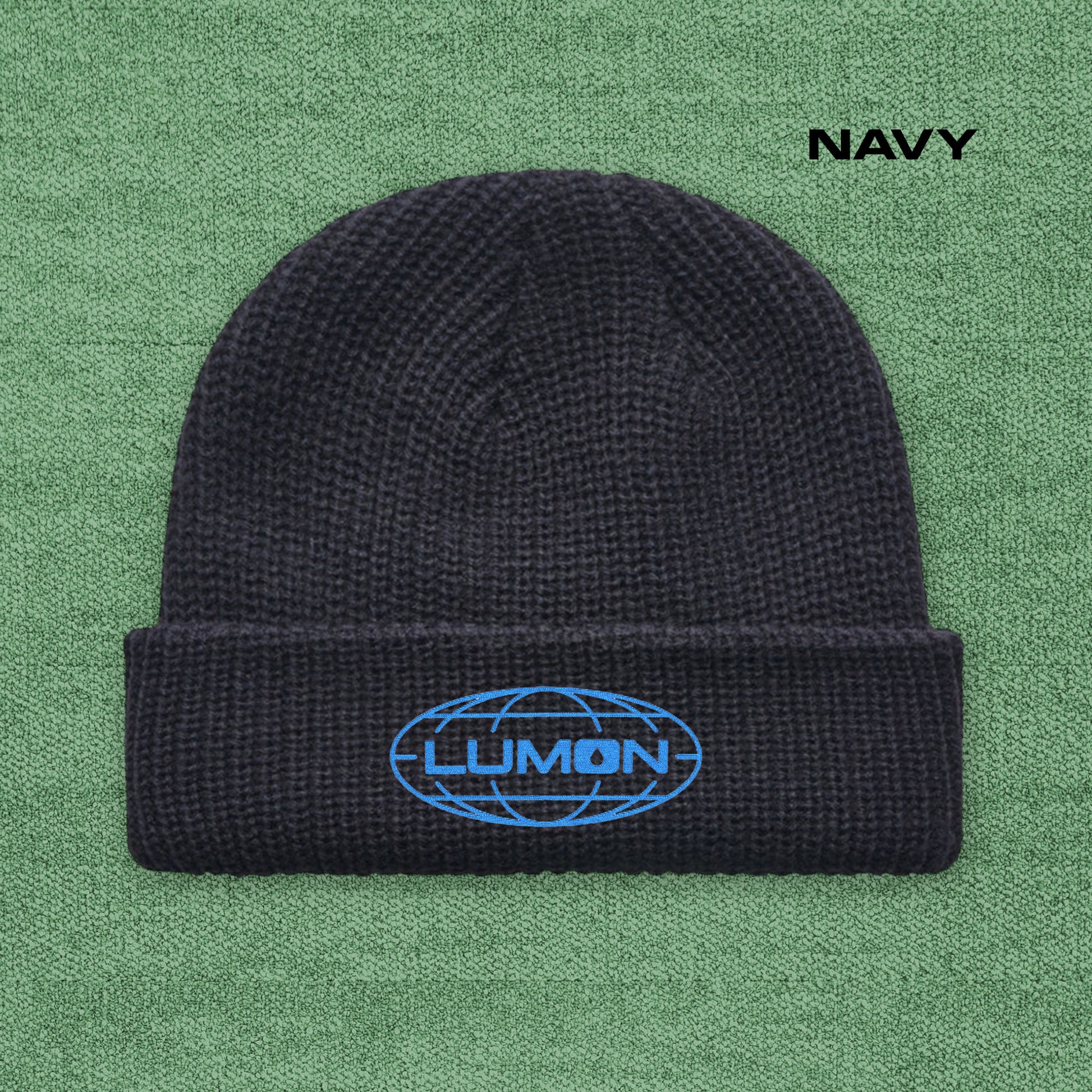 Navy AS Colour cuff beanie with embroidered blue Lumon Industries logo from Severance, fisherman-style ribbed knit hat.