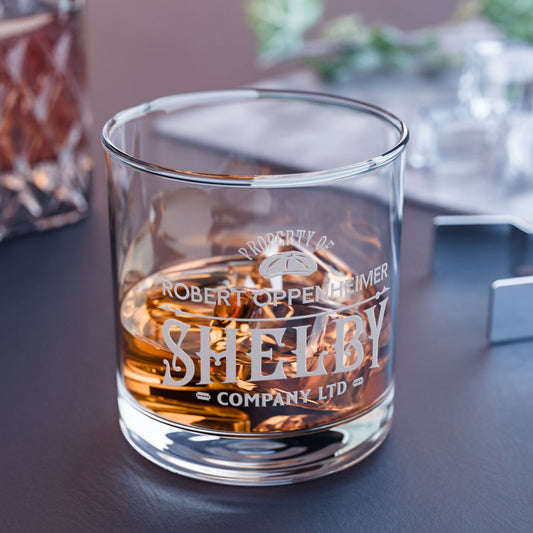 Personalized 10 oz rocks glass with Shelby Company Limited Peaky Blinders inspired logo and custom name, shown on a table.