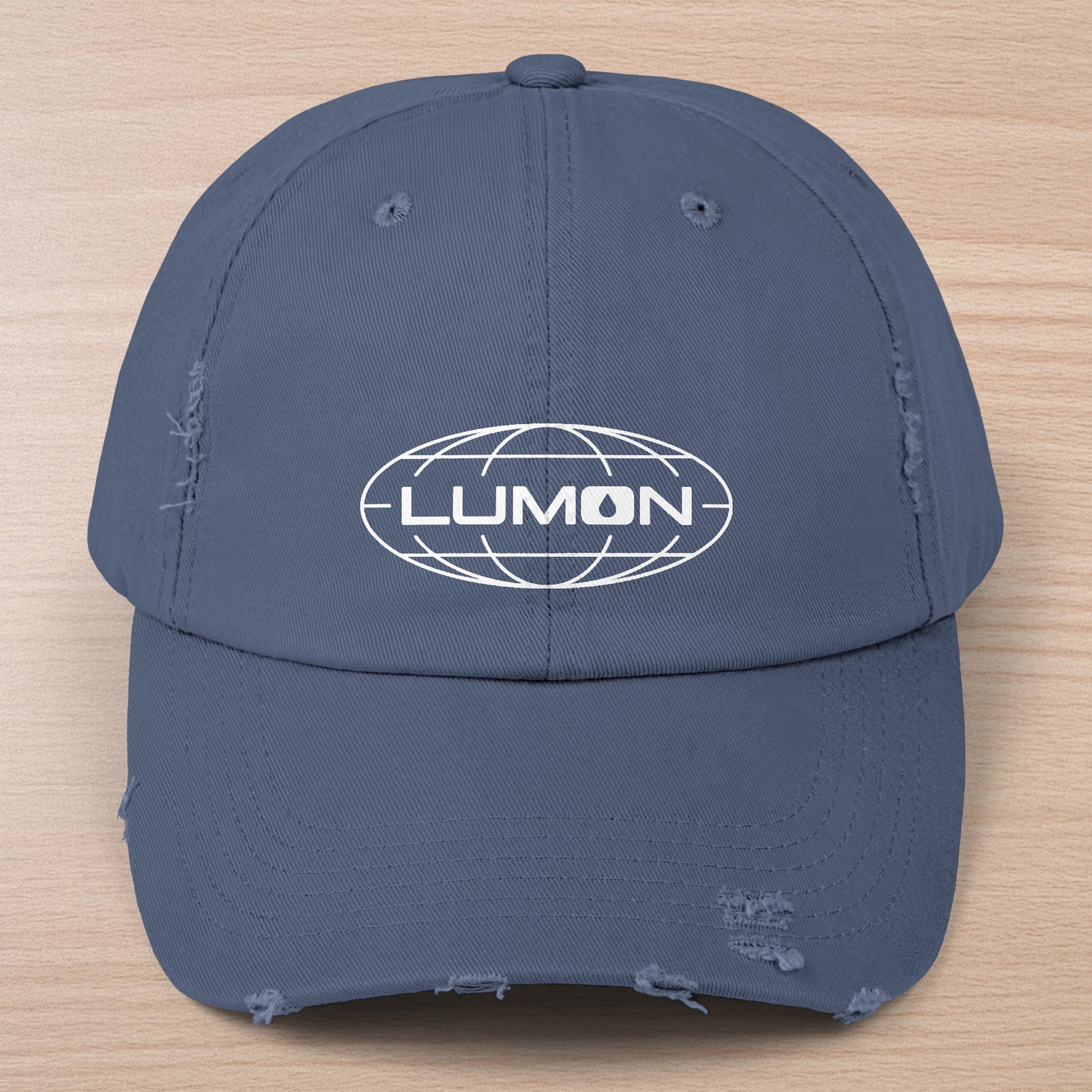 Scotland blue District DT600 Vintage Distressed Baseball Cap with the Lumon Industries logo from the show Severance.