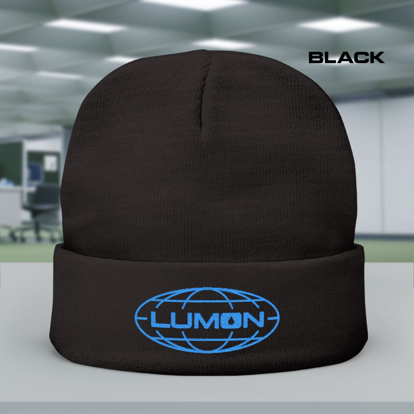 Black knit beanie with embroidered blue Lumon Industries logo from Apple TV’s Severance.